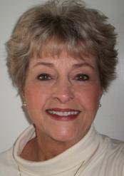 A woman with short hair smiles for the camera.